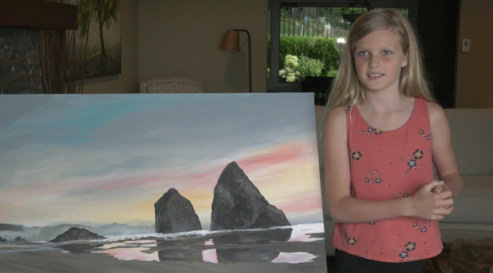 Kate Morrissy pictured with art piece that sold for $1,000