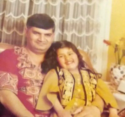 A young Nageena GIll with her father