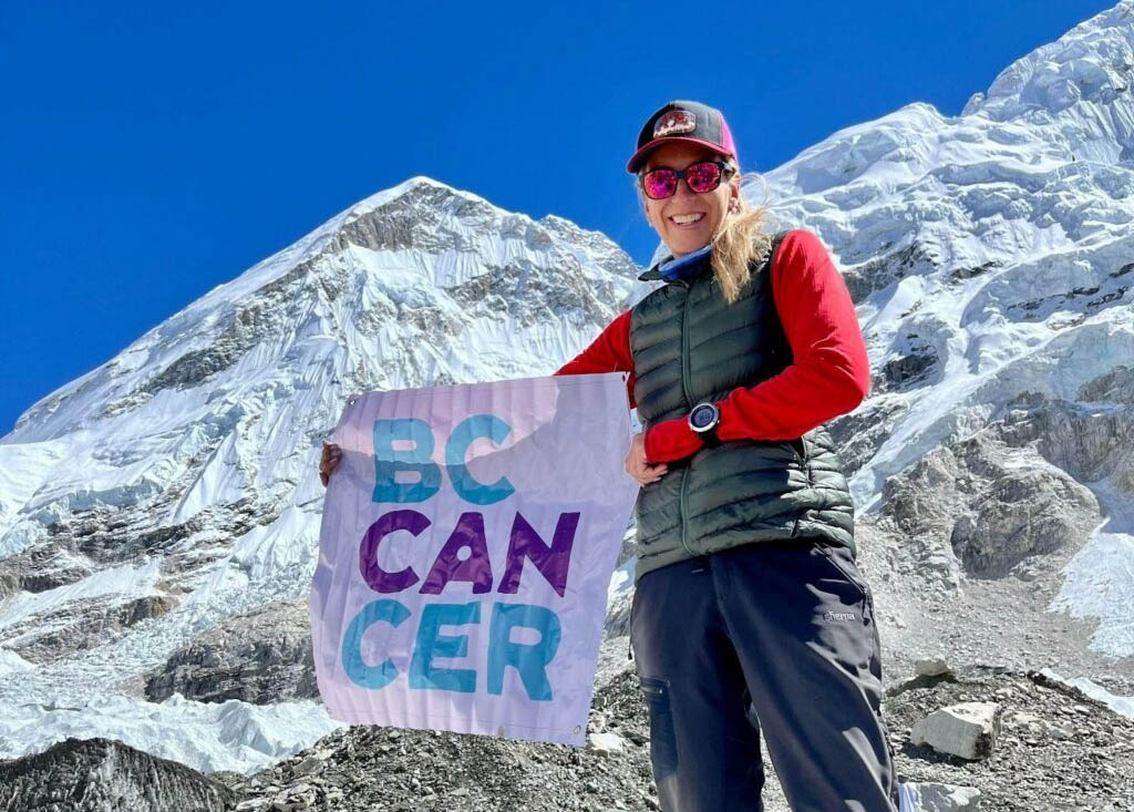 Heather Geluk showing her support of BC Cancer banner from Everest Base Camp